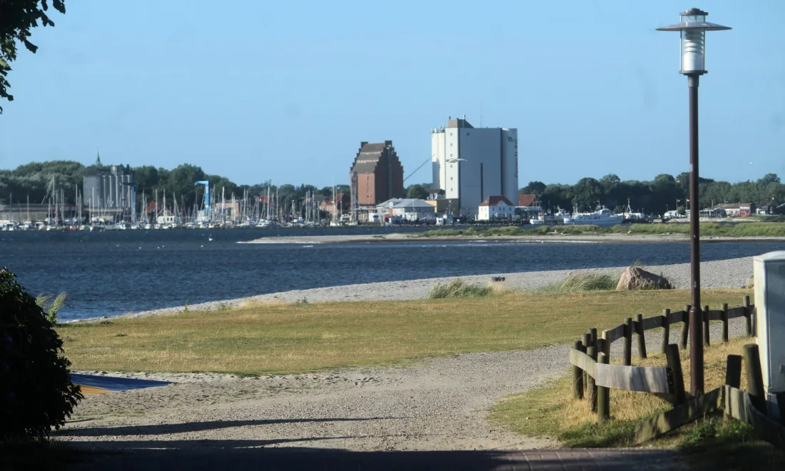 Hafen auf Fehmarn mit Booten und Strand im Vordergrund